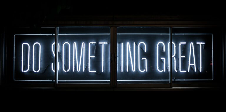 sign in the dark saying in blue colour Do Something Great