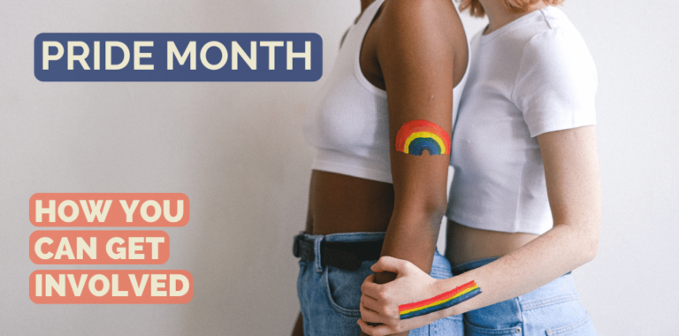 Two people with rainbows painted on their arms embrace each other.