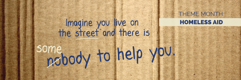 Cover picture for the theme month Homeless Aid with a piece of cardboard as background and the inscription: imagine you are living on the street and someone is helping you.