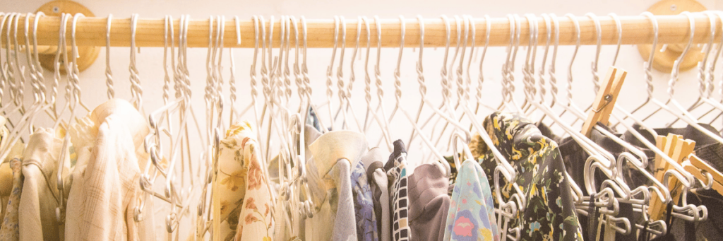 A clothes rail with various items of clothing on it