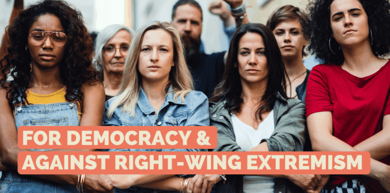 Group of people standing resolutely together hand in hand and looking into the camera