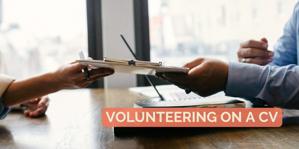 A person hands a CV to another person.